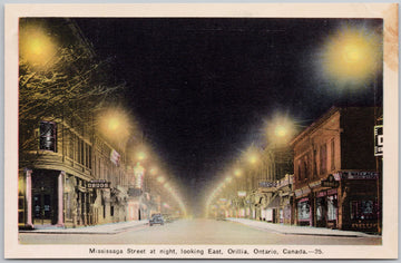 Vintage night scene of a street in Orillia, Ontario, Canada with illuminated buildings and streetlights.